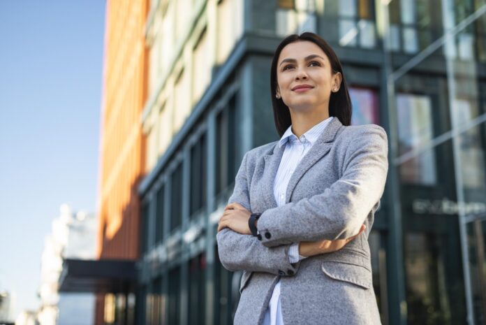 low-angle-businesswoman-posing-with-arms-crossed-outdoors.jpg