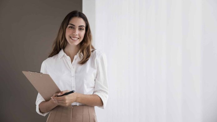 front-view-elegant-businesswoman-holding-clipboard-with-copy-space-scaled.jpg
